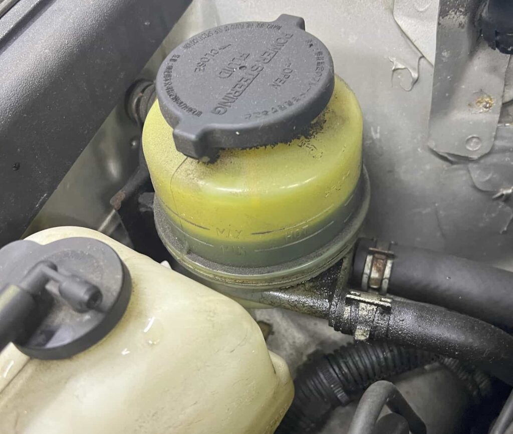 POWER STEERING FLUID CONTAINER